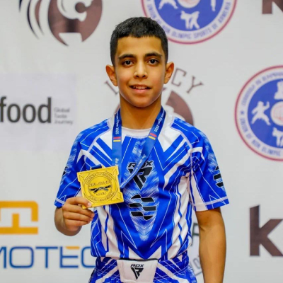 Mark Ghambaryan standing on the podium after winning the gold medal at the Jiu-Jitsu Armenian Open Championship.