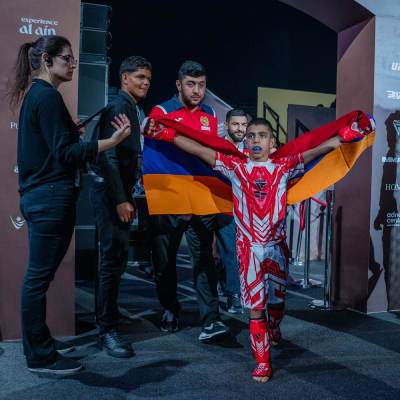 Mark Ghambaryan walking to the cage with Armenian flag and coaches before his fight at the IMMAF World Championship 2025